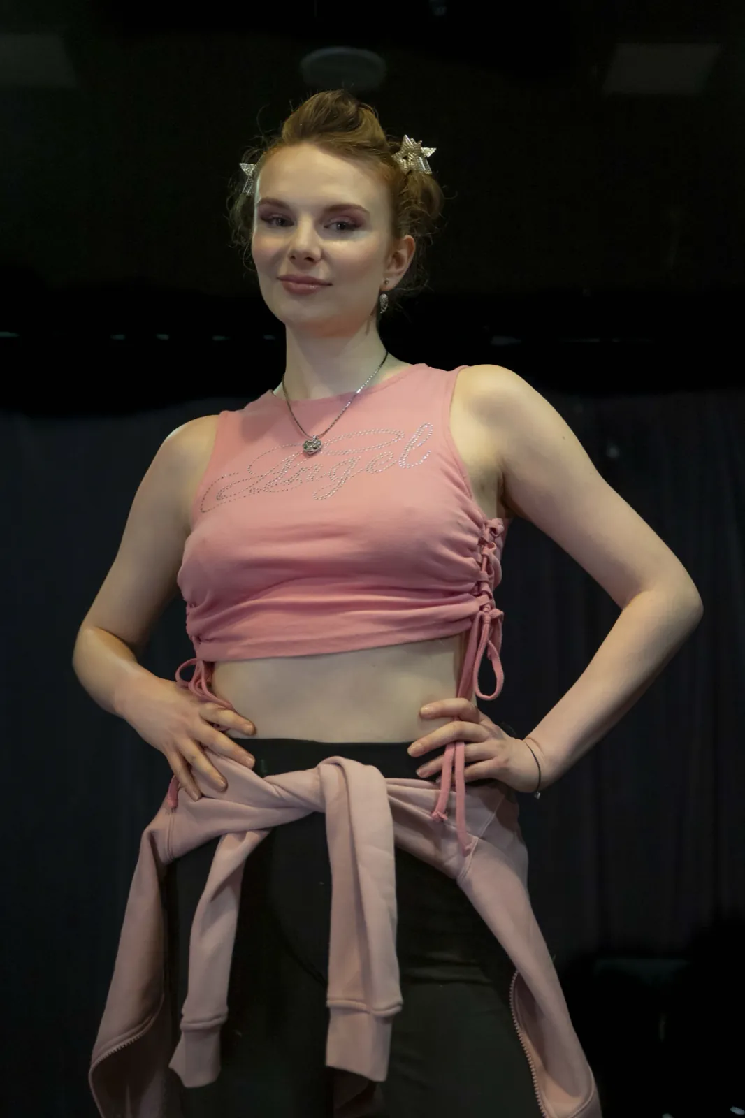 A dancer in a pink crop top on the club stage