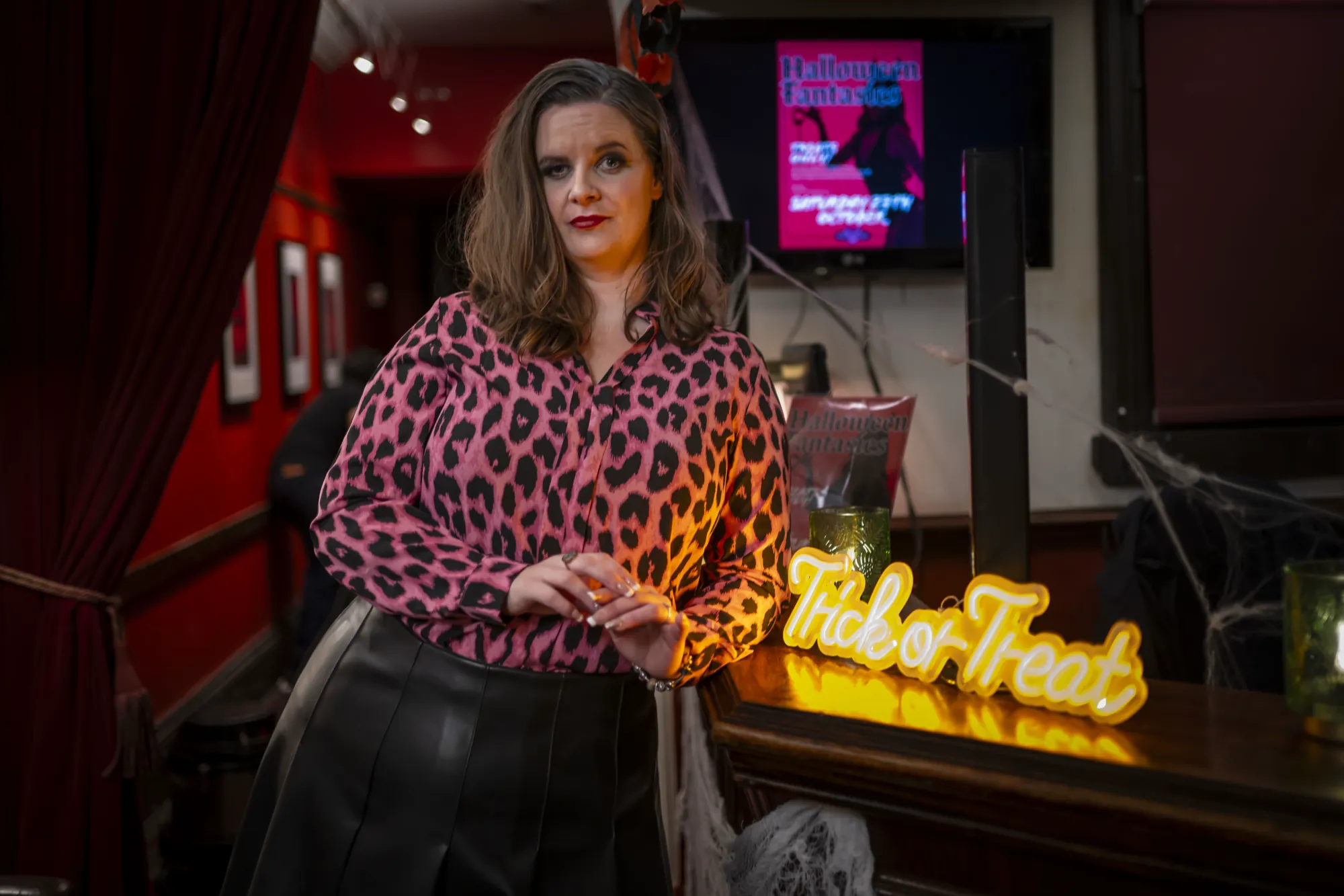 Sharon, the club’s boss, at the bar beside a Trick or Treat sign